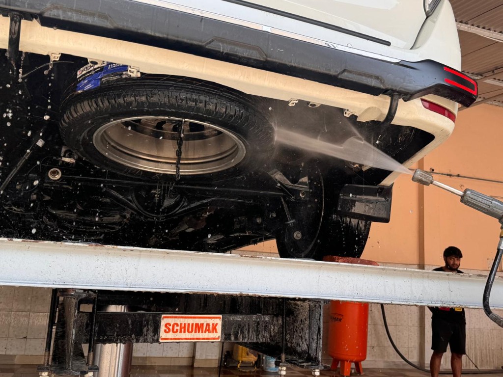 Car raised on hydraulic lift