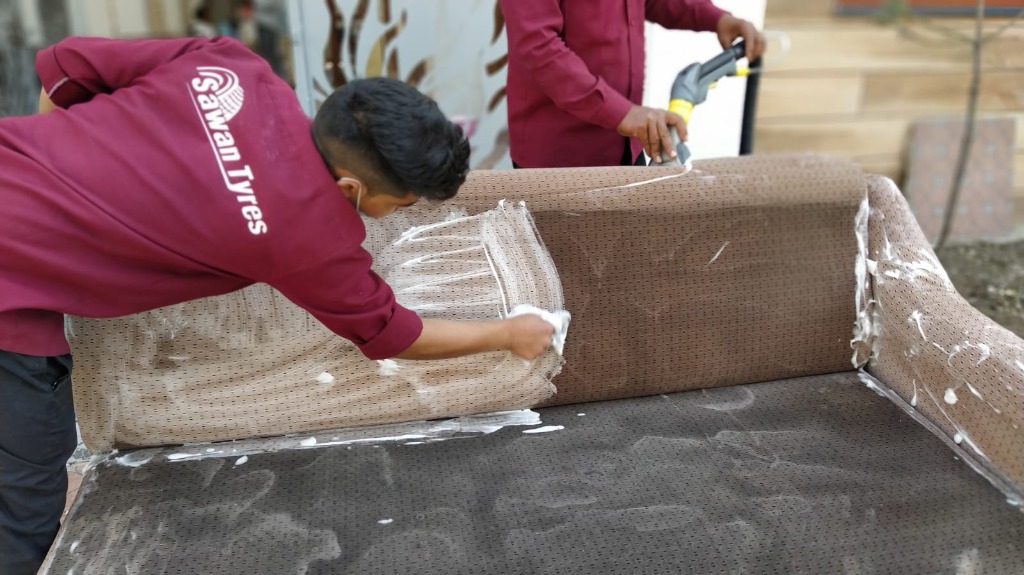 Workers cleaning sofa